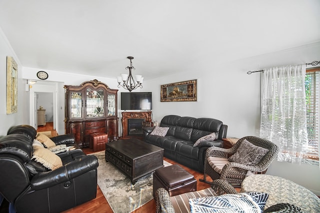 living room with hardwood / wood-style floors and a notable chandelier