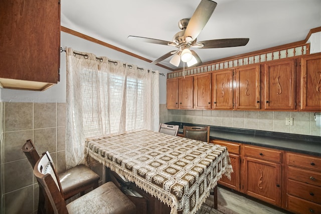 kitchen featuring ornamental molding, decorative backsplash, light hardwood / wood-style flooring, and ceiling fan