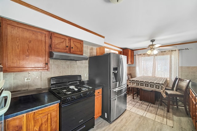 kitchen with light hardwood / wood-style floors, stainless steel refrigerator with ice dispenser, ceiling fan, crown molding, and black gas stove