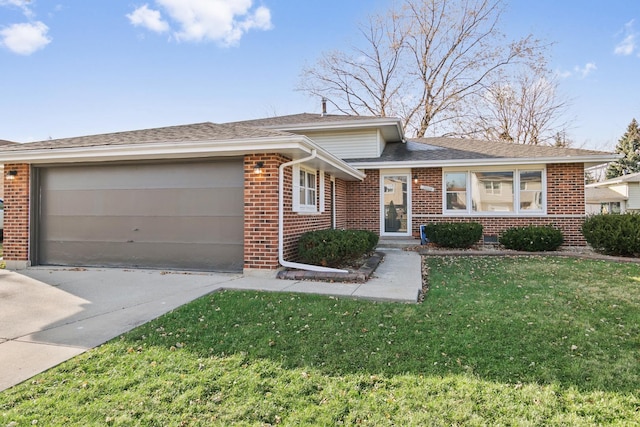 view of front of property with a garage and a front lawn