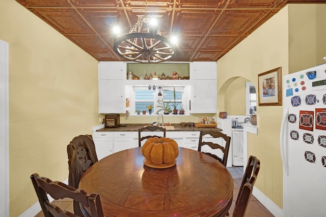 tiled dining room featuring sink