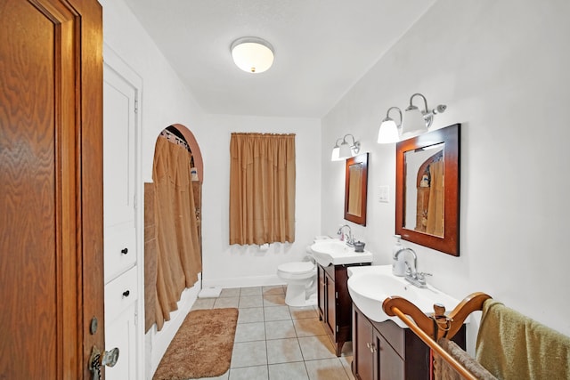 bathroom featuring tile patterned flooring, vanity, and toilet