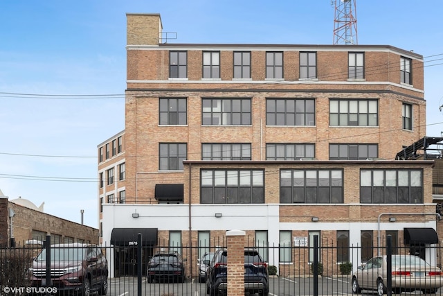 2675 W Grand Ave Unit 302, Chicago, IL 60612 - view of building exterior featuring a fenced front yard