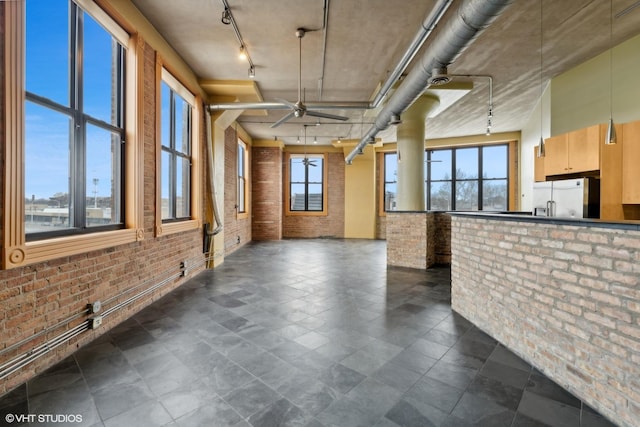 2675 W Grand Ave Unit 302, Chicago, IL 60612 - interior space with track lighting, a ceiling fan, and brick wall