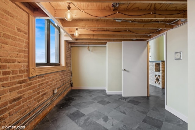 2675 W Grand Ave Unit 302, Chicago, IL 60612 - basement with baseboards and brick wall