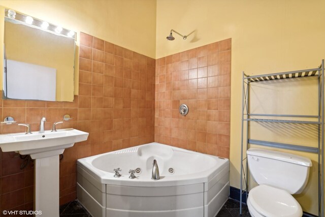 2675 W Grand Ave Unit 302, Chicago, IL 60612 - full bath featuring tile walls, toilet, a tub with jets, and a shower