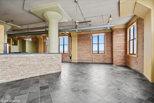 2675 W Grand Ave Unit 302, Chicago, IL 60612 - interior space with brick wall, a healthy amount of sunlight, and rail lighting