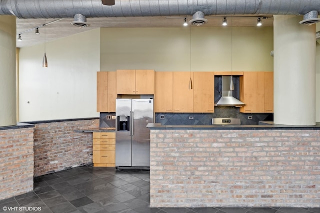 2675 W Grand Ave Unit 302, Chicago, IL 60612 - kitchen featuring wall chimney range hood, a high ceiling, dark countertops, track lighting, and stainless steel refrigerator with ice dispenser