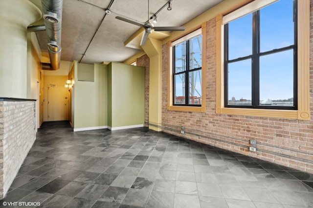 2675 W Grand Ave Unit 302, Chicago, IL 60612 - interior space featuring baseboards, ceiling fan, and brick wall