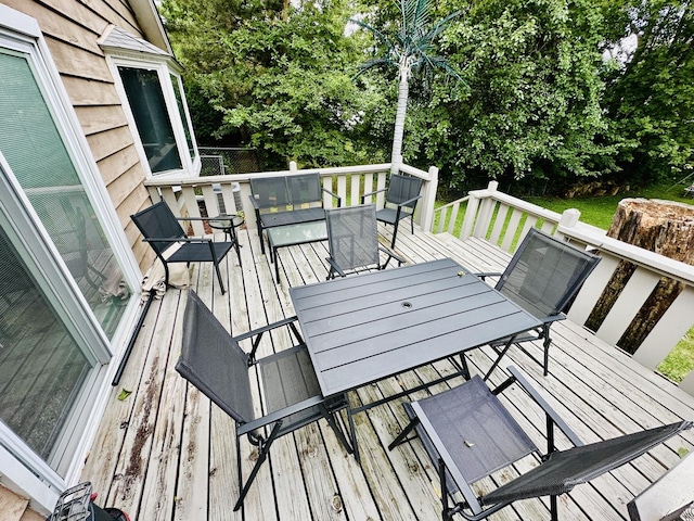 wooden terrace featuring outdoor dining area