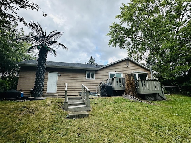 back of house with a yard and a deck