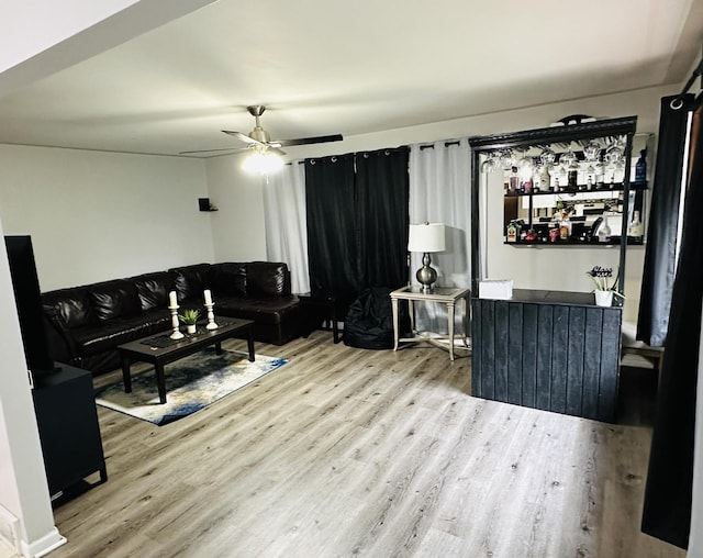 living area featuring wood finished floors and a ceiling fan