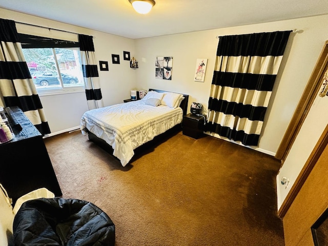 carpeted bedroom featuring baseboards