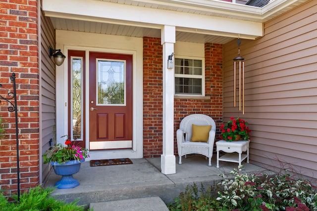 view of exterior entry with a porch