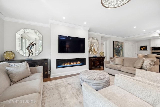 living area with a glass covered fireplace, crown molding, recessed lighting, and wood finished floors