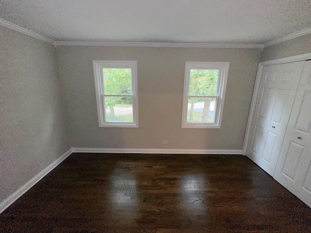 unfurnished room with dark hardwood / wood-style floors and ornamental molding