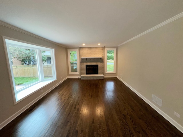 unfurnished living room featuring crown molding, dark hardwood / wood-style floors, and a fireplace