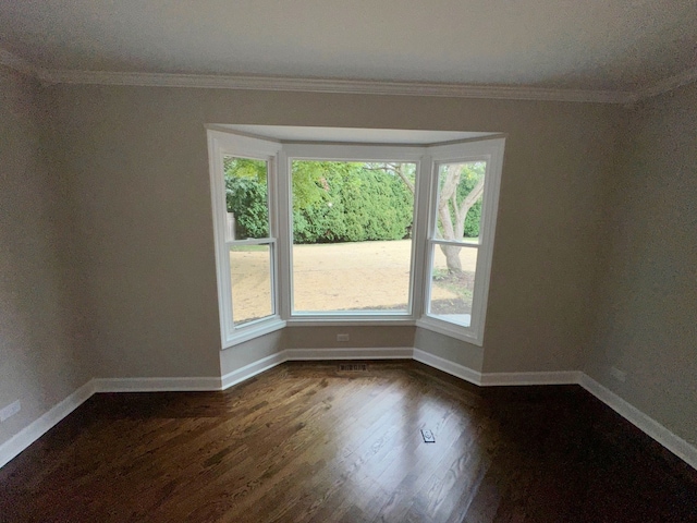 unfurnished room featuring ornamental molding and dark hardwood / wood-style floors