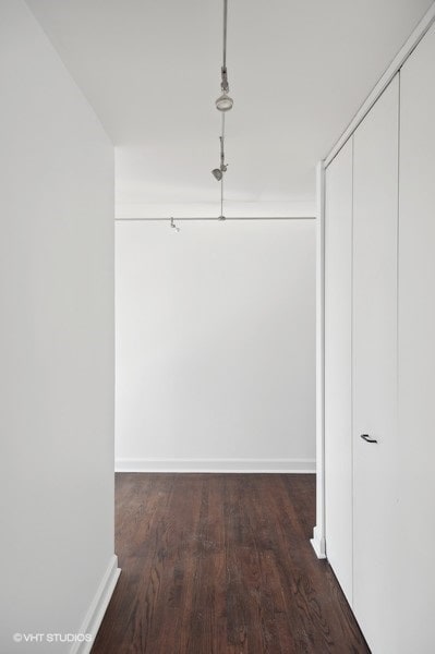 corridor with dark wood-type flooring