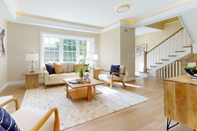 living room featuring crown molding and light hardwood / wood-style floors