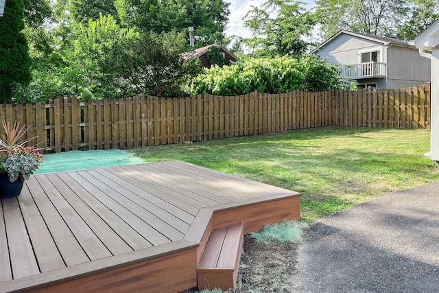 wooden deck with a lawn