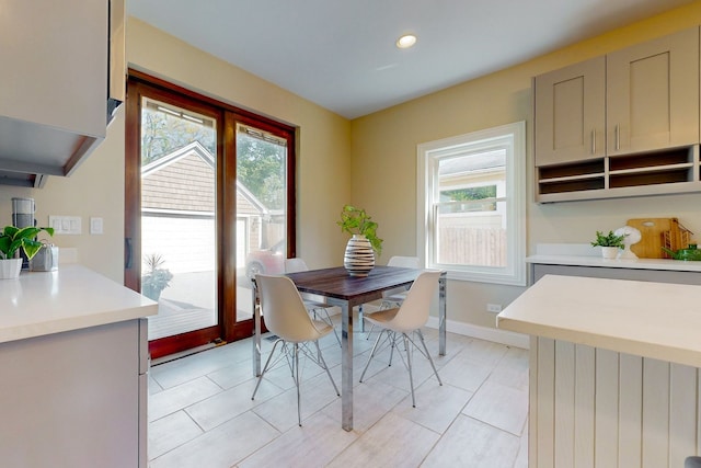 dining space with light tile patterned floors and a wealth of natural light