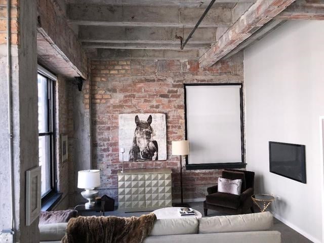 living room featuring brick wall