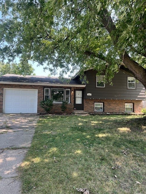 tri-level home with a front yard and a garage