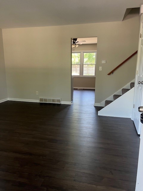 interior space with ceiling fan and dark hardwood / wood-style flooring