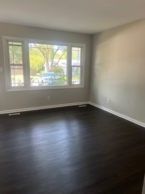 spare room featuring dark hardwood / wood-style flooring