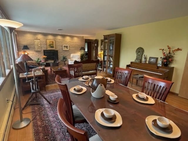 dining room featuring baseboard heating and hardwood / wood-style floors