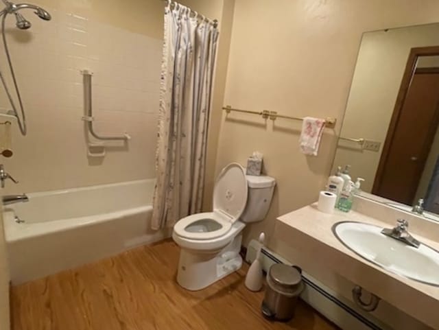 full bathroom with vanity, shower / bath combination with curtain, hardwood / wood-style flooring, and toilet