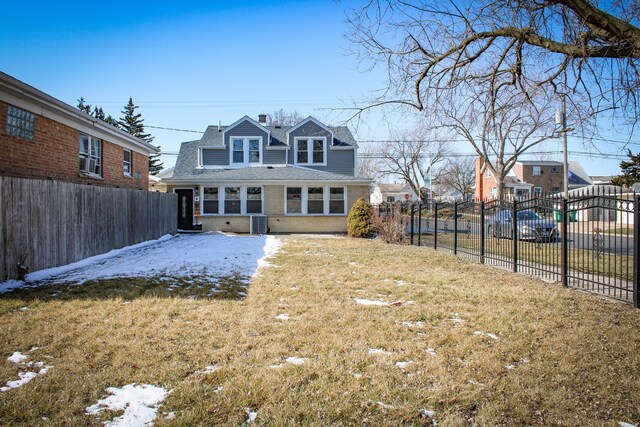 back of house with a yard and central AC