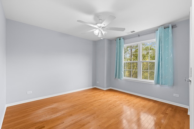 unfurnished room with ceiling fan and wood-type flooring