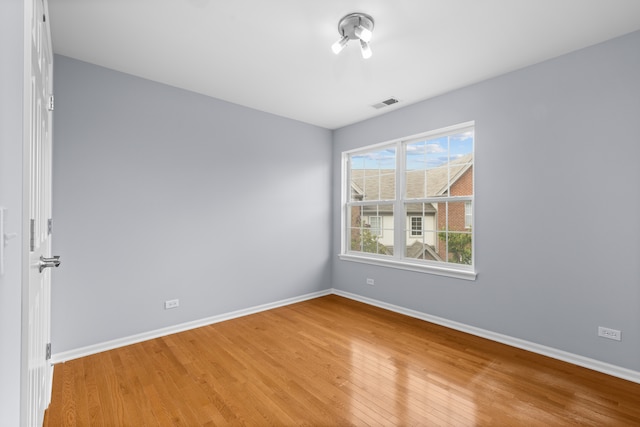 unfurnished room with wood-type flooring