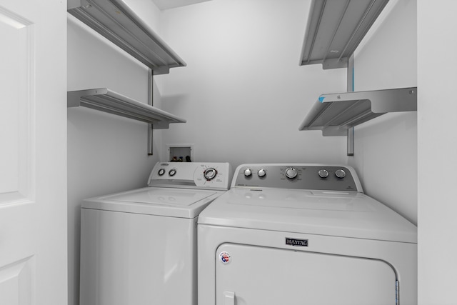 clothes washing area with washing machine and clothes dryer