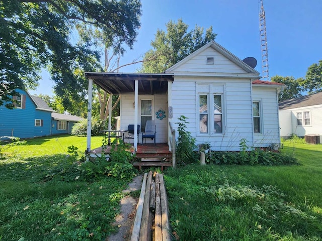 bungalow-style home with a porch, central AC, and a front yard