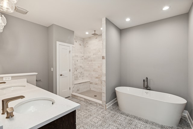 bathroom with tile patterned flooring, vanity, and separate shower and tub