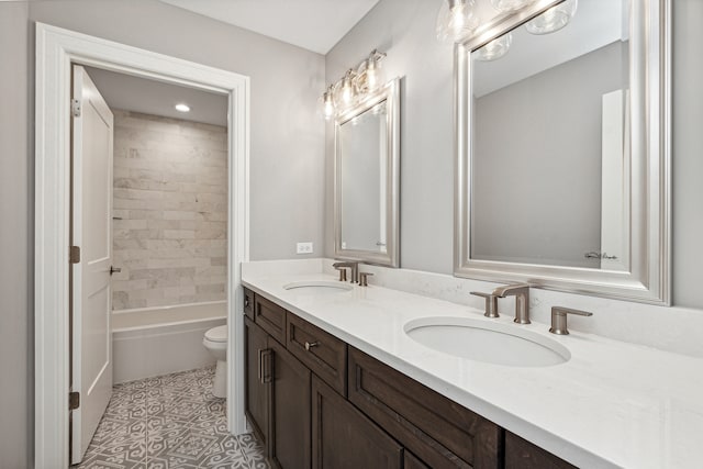 full bathroom featuring tiled shower / bath, toilet, and vanity