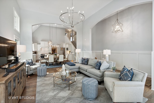 living room with high vaulted ceiling and wood-type flooring