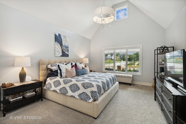 carpeted bedroom with high vaulted ceiling and a chandelier