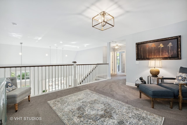 living area with carpet, a notable chandelier, and plenty of natural light