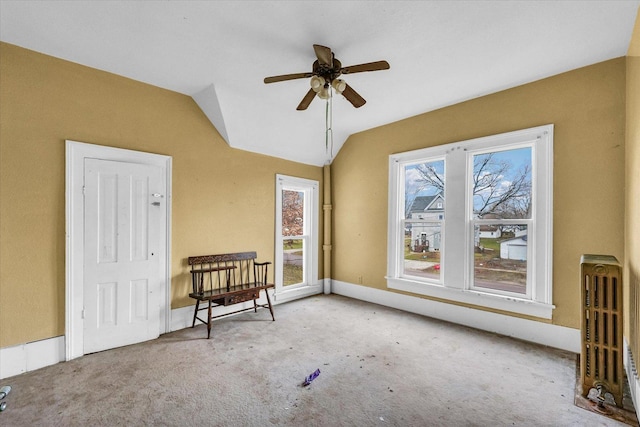 interior space featuring ceiling fan, radiator, and vaulted ceiling