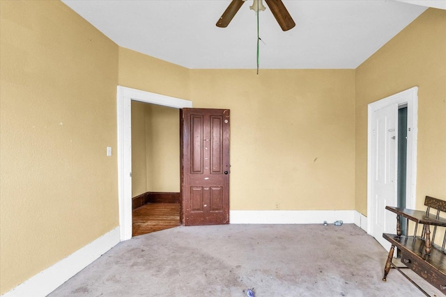 empty room featuring ceiling fan and light carpet