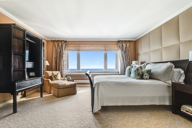 bedroom with a water view, carpet floors, and ornamental molding