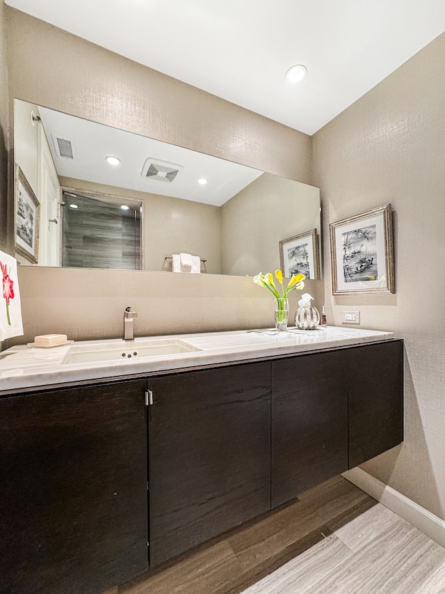 bathroom featuring vanity and hardwood / wood-style flooring