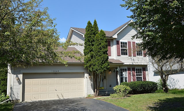 view of front facade with a garage and a front lawn