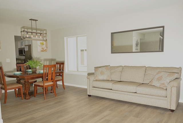 living room with an inviting chandelier and hardwood / wood-style floors