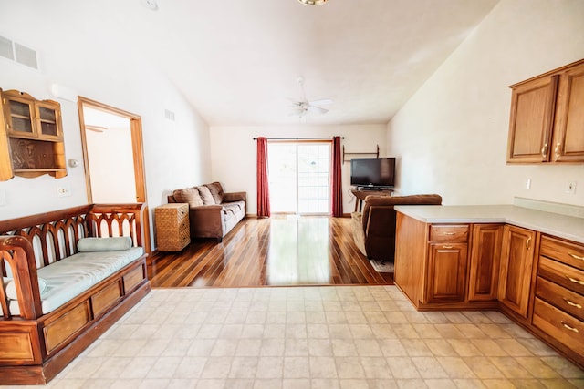 interior space with vaulted ceiling, ceiling fan, and light hardwood / wood-style floors