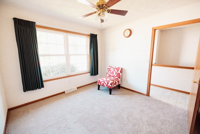 living area featuring ceiling fan and carpet floors